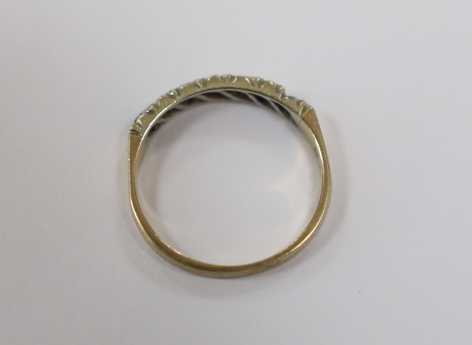 A modern 9ct gold, four stone sapphire and three stone diamond chip set half hoop ring, size N, gross weight 2 grams.